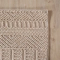 dywan-nowoczesny-3d-helix-boho-bezowy-zblizenie-rogu-dywanu-z-widocznym-obszyciem-obu-bokow.jpg