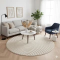 dywan-nowoczesny-art-3d-geometria-kremowy-kolo-aranzacja-w-salonie-z-jasna-sofa-duzym-oknem-w-tle-i-niebieskim-fotelem-na-srodku-dywanu-stolik-kawowy.jpg