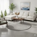 dywan-nowoczesny-art-3d-geometria-szary-kolo-aranzacja-na-jasnej-podlodze-z-jasna-sofa-i-oknem-w-tle-stolikiem-kawowym na -srodku-dywanu-i-fotelem.jpg